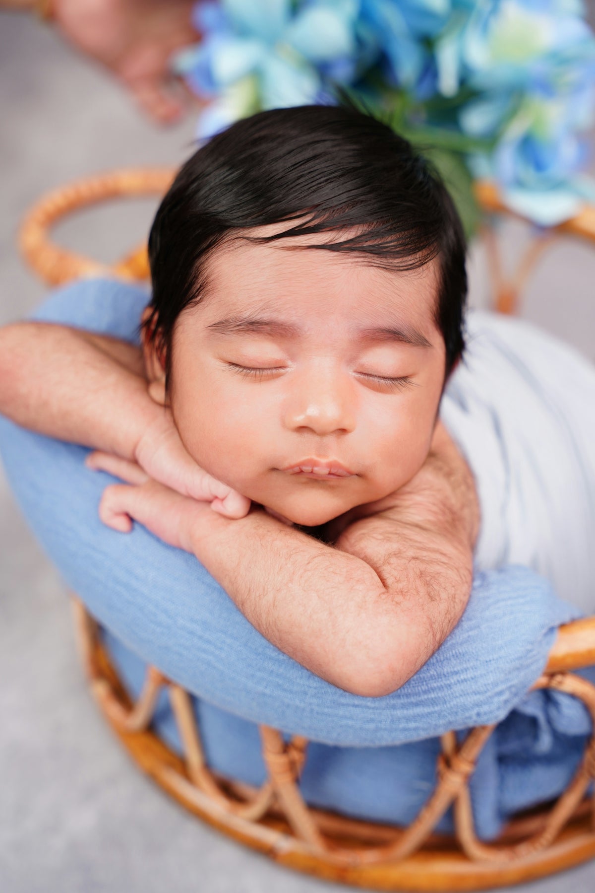 A sleeping newborn baby in a basket