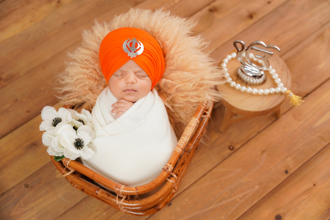 Newborn baby in turban with flowers and flowers