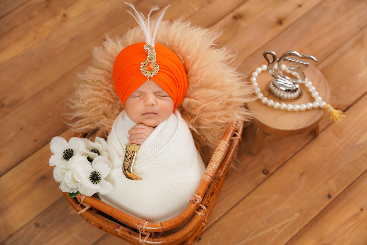 Newborn baby in a turban and swaddle